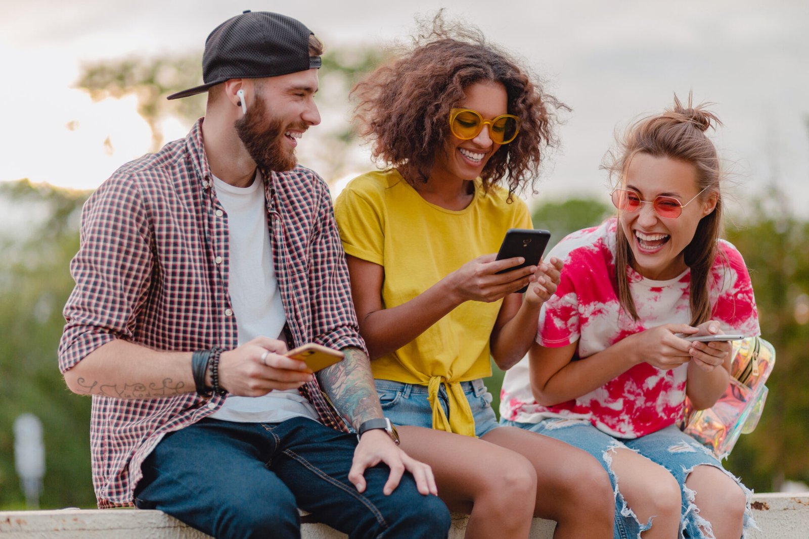 happy-young-company-smiling-friends-sitting-park-using-smartphones-man-women-having-fun.jpg